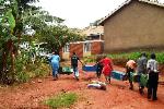 Agnes and the kids form a human chain to haul their lockers to the transport lorry.
